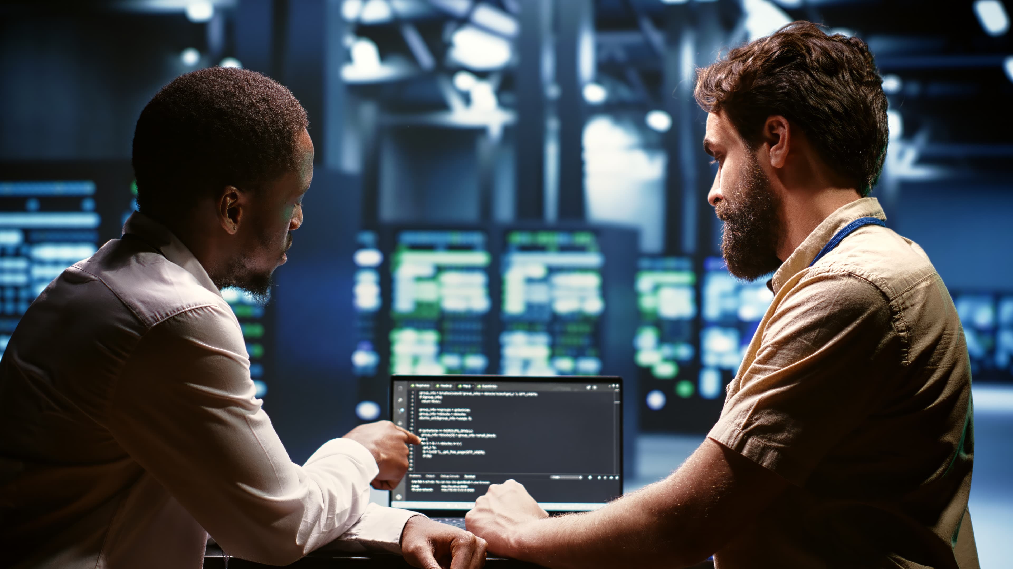 Two Nidham consultants working through a solution together in a data centre
